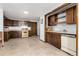 Small basement kitchen with wood cabinets and appliances at 7846 Village Rd, Parker, CO 80134