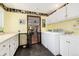 Laundry room with washer, dryer, and built-in cabinets at 7846 Village Rd, Parker, CO 80134
