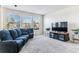 Living room with large sectional sofa and flat-screen TV at 325 Crosshaven Pl, Castle Rock, CO 80104