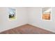 Simple bedroom with neutral carpeting and two large windows at 1565 Xanthia St, Denver, CO 80220
