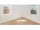 Bright bedroom with neutral carpeting and two windows at 1565 Xanthia St, Denver, CO 80220