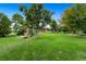 Large backyard with lush green grass and mature trees at 6960 E County Line Road 1, Longmont, CO 80504