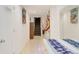 Bright basement hallway with tiled floor, staircase, and decorative wall hangings at 6960 E County Line Road 1, Longmont, CO 80504