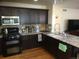 Kitchen features granite counters, dark cabinets, and stainless steel appliances at 13674 Plaster Cir, Broomfield, CO 80023