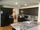 Modern kitchen with granite countertops and stainless steel appliances at 13674 Plaster Cir, Broomfield, CO 80023