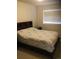 Bedroom with a queen bed, nightstand, and window with blinds at 13674 Plaster Cir, Broomfield, CO 80023