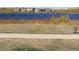 Lakefront view of houses and bench for relaxing at 13674 Plaster Cir, Broomfield, CO 80023