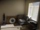 Bright office features window with blinds, comfy chair, and small table at 13674 Plaster Cir, Broomfield, CO 80023
