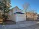 Attached two-car garage with a circular driveway at 1011 S Valentia St # 136, Denver, CO 80247