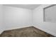 Bright bedroom featuring neutral walls and carpet at 6607 S Kewaunee Way, Aurora, CO 80016