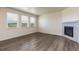 Living room with hardwood floors, fireplace, and large windows at 15898 Little Bluestem Rd, Monument, CO 80132