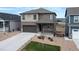 Two-story house with brown and beige siding, stone accents, and a two-car garage at 15898 Little Bluestem Rd, Monument, CO 80132