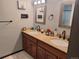 Bathroom with double vanity, granite countertop, and tile floor at 3550 S Harlan St # 313, Denver, CO 80235