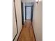 Clean hallway with light wood flooring and neutral walls at 3550 S Harlan St # 313, Denver, CO 80235