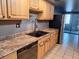 Kitchen with light wood cabinets, double sink, and dishwasher at 3550 S Harlan St # 313, Denver, CO 80235