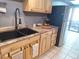 Modern kitchen with double sink, granite countertops, and stainless steel appliances at 3550 S Harlan St # 313, Denver, CO 80235