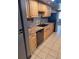 Kitchen with light wood cabinets, double sink, and dishwasher at 3550 S Harlan St # 313, Denver, CO 80235