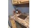 Kitchen features granite countertops and wood cabinets at 3550 S Harlan St # 313, Denver, CO 80235