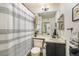 Clean bathroom with a striped shower curtain and updated vanity at 9510 E Florida Ave # 2052, Denver, CO 80247
