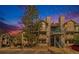 Evening view of a two-story condo building with landscaping at 9510 E Florida Ave # 2052, Denver, CO 80247