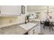 Kitchen features granite countertops and a double sink at 9510 E Florida Ave # 2052, Denver, CO 80247