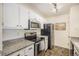 Updated kitchen featuring stainless steel appliances and granite countertops at 9510 E Florida Ave # 2052, Denver, CO 80247