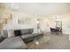 Living room with sectional sofa, coffee table, and access to balcony at 9510 E Florida Ave # 2052, Denver, CO 80247