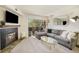 Living room featuring a sectional sofa, coffee table, and fireplace at 9510 E Florida Ave # 2052, Denver, CO 80247
