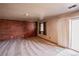 Gathering room featuring a wood accent wall and sliding door access at 341 N 18Th Ct, Brighton, CO 80601