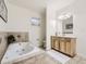 Bathroom with soaking tub and light wood cabinets at 1658 S Milwaukee St, Denver, CO 80210