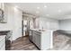 Modern kitchen with island, stainless steel appliances, and open layout at 5793 Farmstead Pl, Mead, CO 80504