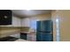 Modern kitchen with teal appliances and ample counter space at 1940 Quince St, Denver, CO 80220