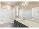 Clean bathroom with a bathtub, shower, and dark green vanity at 21278 E 63Rd Dr, Aurora, CO 80019