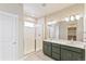Elegant bathroom with double vanity, large mirror, and walk-in shower at 21278 E 63Rd Dr, Aurora, CO 80019