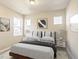 Well-lit bedroom with a queen-size bed and neutral decor at 21278 E 63Rd Dr, Aurora, CO 80019