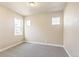 Well-lit bedroom featuring two windows and carpet flooring at 21278 E 63Rd Dr, Aurora, CO 80019