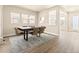 Bright dining room with hardwood floors and a modern dining table at 21278 E 63Rd Dr, Aurora, CO 80019