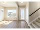 Bright and airy entryway with hardwood floors and staircase at 21278 E 63Rd Dr, Aurora, CO 80019