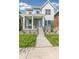 Two-story house with light blue siding, brick accents, and a front porch at 21278 E 63Rd Dr, Aurora, CO 80019