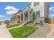 Two-story home with light blue and gray siding, a front porch, and landscaped yard at 21278 E 63Rd Dr, Aurora, CO 80019