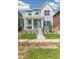 Two-story home with light blue and gray siding, a front porch, and a landscaped yard at 21278 E 63Rd Dr, Aurora, CO 80019