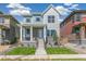 Two-story home with light blue and gray siding, brick accents, and a front porch at 21278 E 63Rd Dr, Aurora, CO 80019