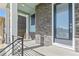 Front porch with modern door and brick exterior at 21278 E 63Rd Dr, Aurora, CO 80019
