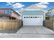 White garage door with driveway and wooden fence at 21278 E 63Rd Dr, Aurora, CO 80019