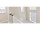 Upstairs hallway with windows and neutral colored walls at 21278 E 63Rd Dr, Aurora, CO 80019