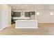 Modern kitchen with dark green cabinets and quartz countertops at 21278 E 63Rd Dr, Aurora, CO 80019
