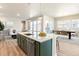 Modern kitchen with an island, stainless steel appliances, and an open floor plan at 21278 E 63Rd Dr, Aurora, CO 80019