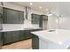 Modern kitchen with dark green cabinets and quartz countertops at 21278 E 63Rd Dr, Aurora, CO 80019