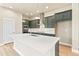 Modern kitchen with dark green cabinets and quartz countertops at 21278 E 63Rd Dr, Aurora, CO 80019