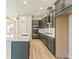 Modern kitchen with dark green cabinets and quartz countertops at 21278 E 63Rd Dr, Aurora, CO 80019